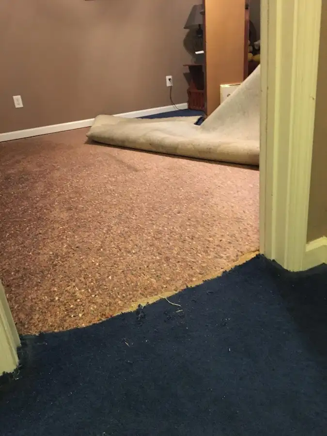 Carpet pad removal revealing water damage during Water Mitigation Services in Windcrest